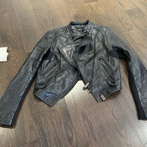 Black leather jacket with knit sleeves.
